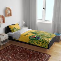 Yellow duvet on bed with green botanical cricket print, Proteas logo, and “YOUR TEXT”