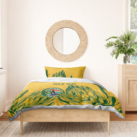 Yellow duvet with green tropical design and Proteas crest, “YOUR TEXT” on bedroom bed