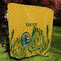 Yellow quilt with diamond stitching and green leaf pattern, “YOUR TEXT” over South Africa crest.