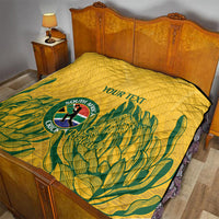 Yellow quilt on bed with diamond quilting, green tropical design, and “YOUR TEXT” label.