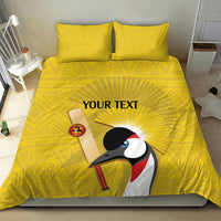 Yellow bedding set with crowned crane artwork centered on duvet and two pillowcases