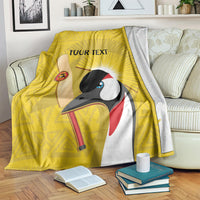Yellow cricket blanket with crowned crane print and 'YOUR TEXT' design