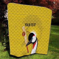 Yellow quilted blanket with black edge, crowned crane graphic, custom text, glowing sun rays