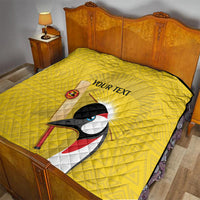 Yellow quilted blanket with black trim, crowned crane and sunburst, custom text centerpiece
