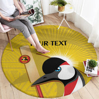 Round yellow carpet with crowned crane graphic, 'YOUR TEXT' and logo patch