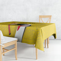 Yellow patterned tablecloth with central bird graphic on a rectangular dining table