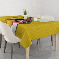Yellow geometric tablecloth with bird graphic and straight drape over a dining table