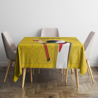 Yellow custom tablecloth with geometric pattern and bird graphic on a square dining table