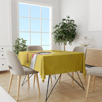 Yellow patterned tablecloth with bird graphic on a dining table surrounded by chairs