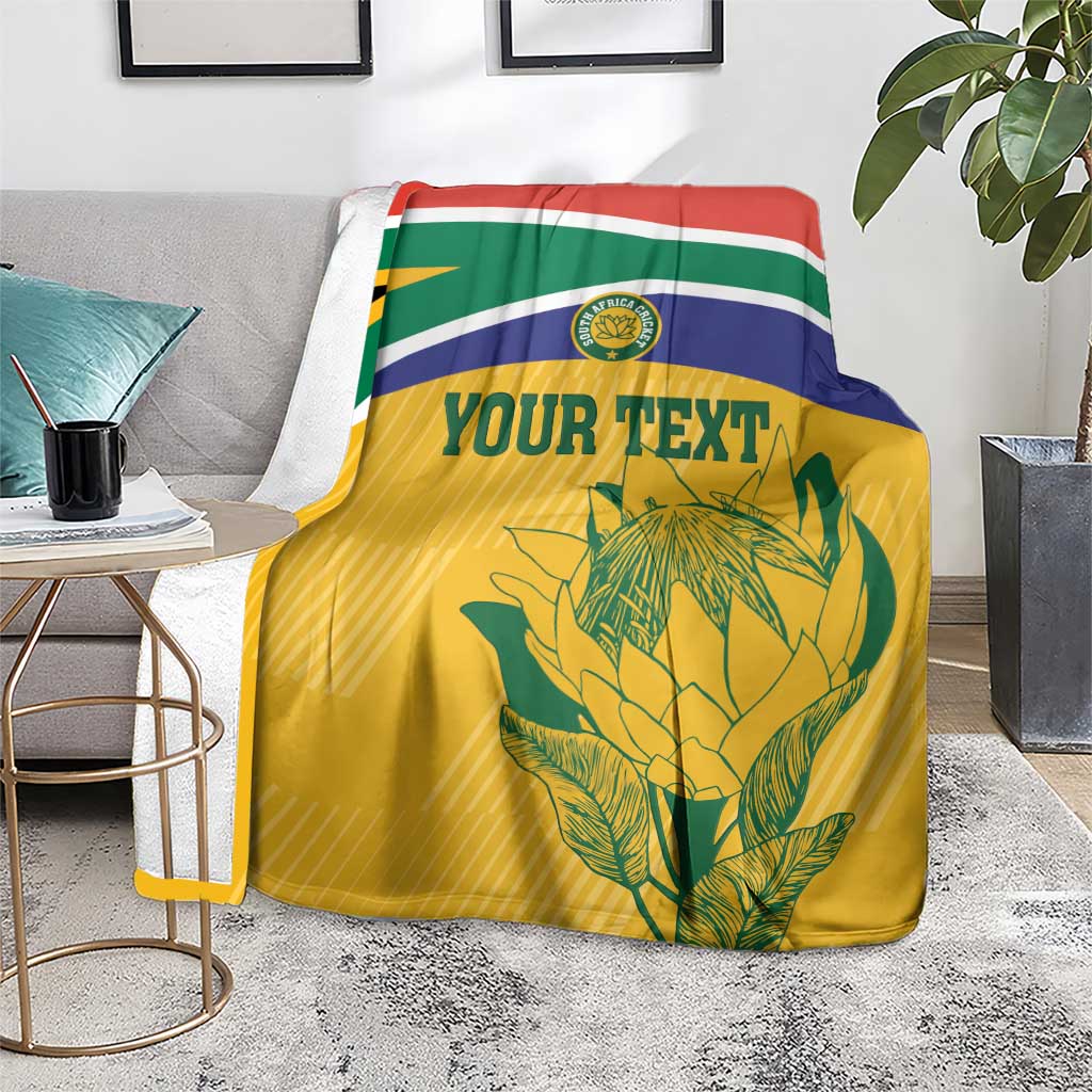 Cricket fan blanket on seat, yellow field with South Africa stripes, 'YOUR TEXT' and Proteas crest