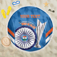 Blue round beach blanket with fringe border, “YOUR TEXT” and circular cricket emblem