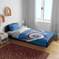 Blue cricket bedding set on bed: duvet and pillow with emblem circle, trophy graphic, striped design