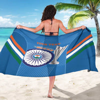 Blue cricket sarong held wide, showing colorful stripes and circular team crest