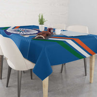 Blue tablecloth with cricket emblem, multi-color stripes, and straight edge drape on table