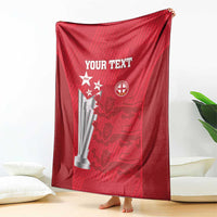 Red cricket blanket draped on floor with 'YOUR TEXT' and team badge