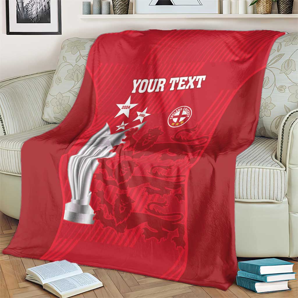 Red cricket blanket over couch with trophy and crest logos, 'YOUR TEXT'