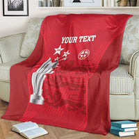Red cricket blanket over couch with trophy and crest logos, 'YOUR TEXT'