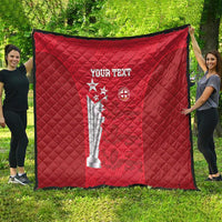 Red quilt with diamond stitching, custom text, and trophy/crest graphic on front