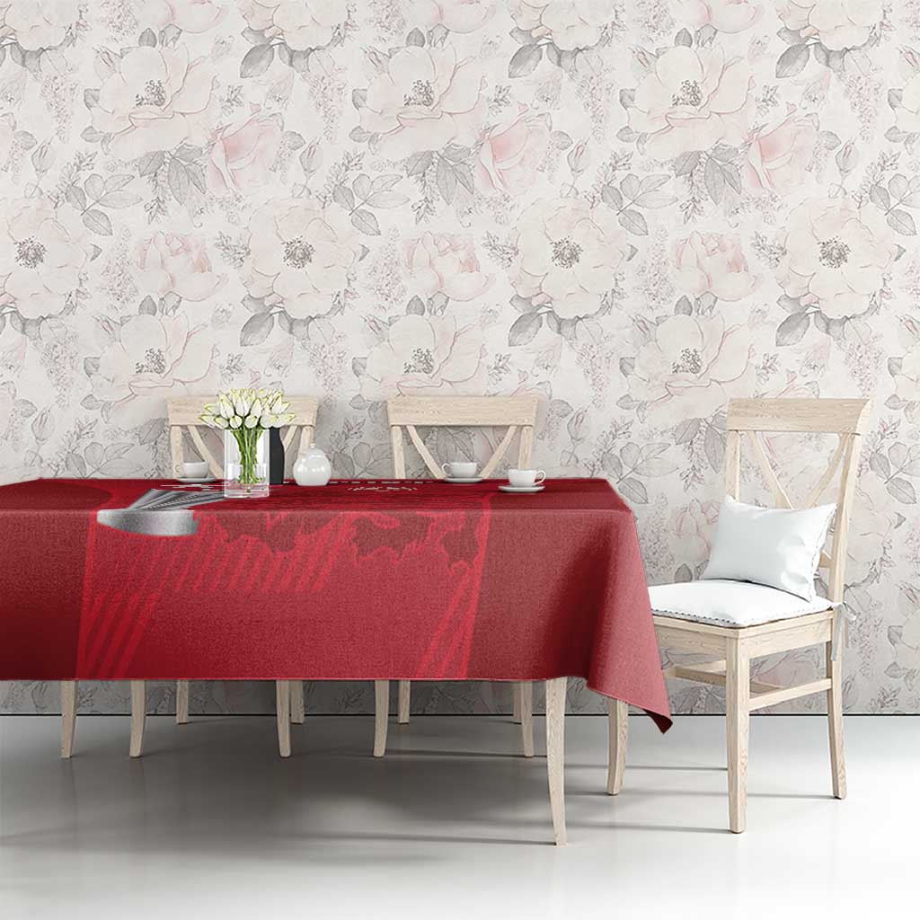 Red tablecloth with cricket-themed design on long dining table, corner overhang