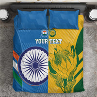 Cricket bedding set close-up: blue duvet with YOUR TEXT, circular emblem, and leaf motif