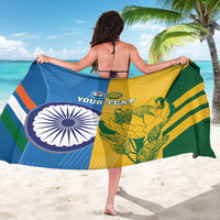 Cricket sarong held wide in blue, yellow, and green with circular logo and tropical leaves