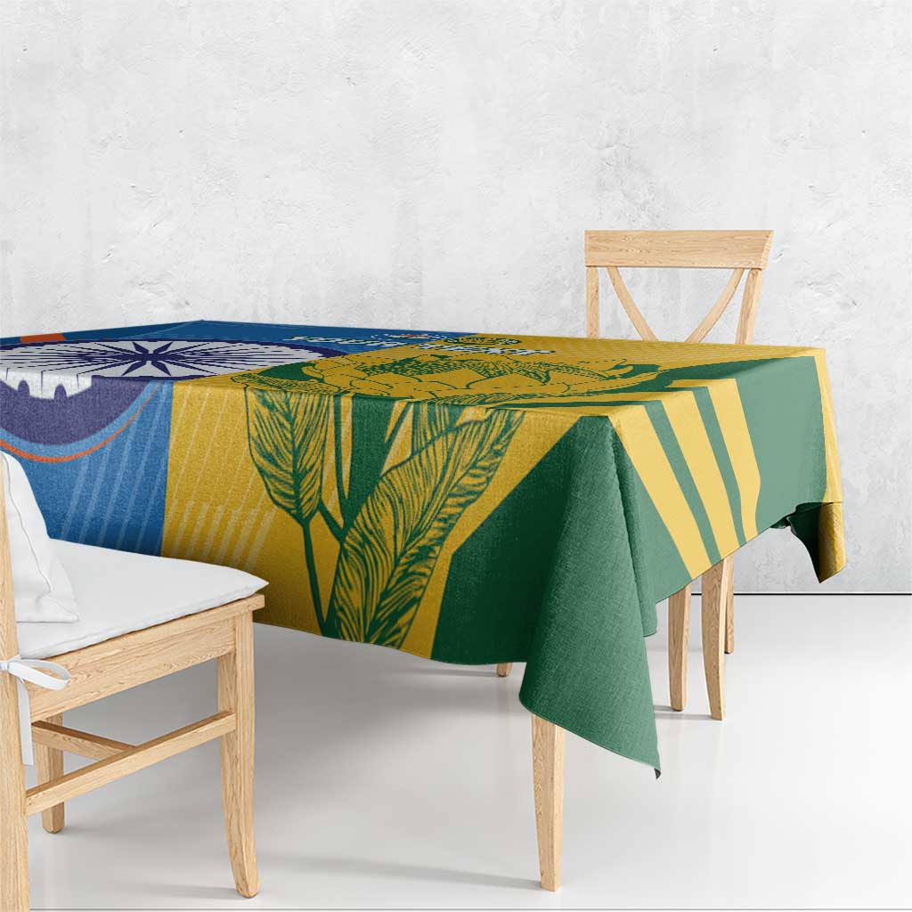 Cricket tablecloth draped on a table in blue, yellow, and green leaf and stripe print