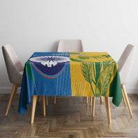 Cricket tablecloth on dining table with blue-to-yellow panels and green leaf pattern