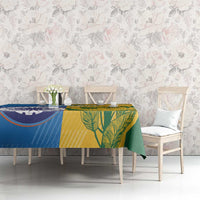 Cricket tablecloth on table with blue and yellow panels and green tropical leaf design
