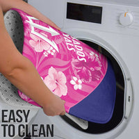 Pink and navy bath mat with floral Barbados Royals print, shown being cleaned