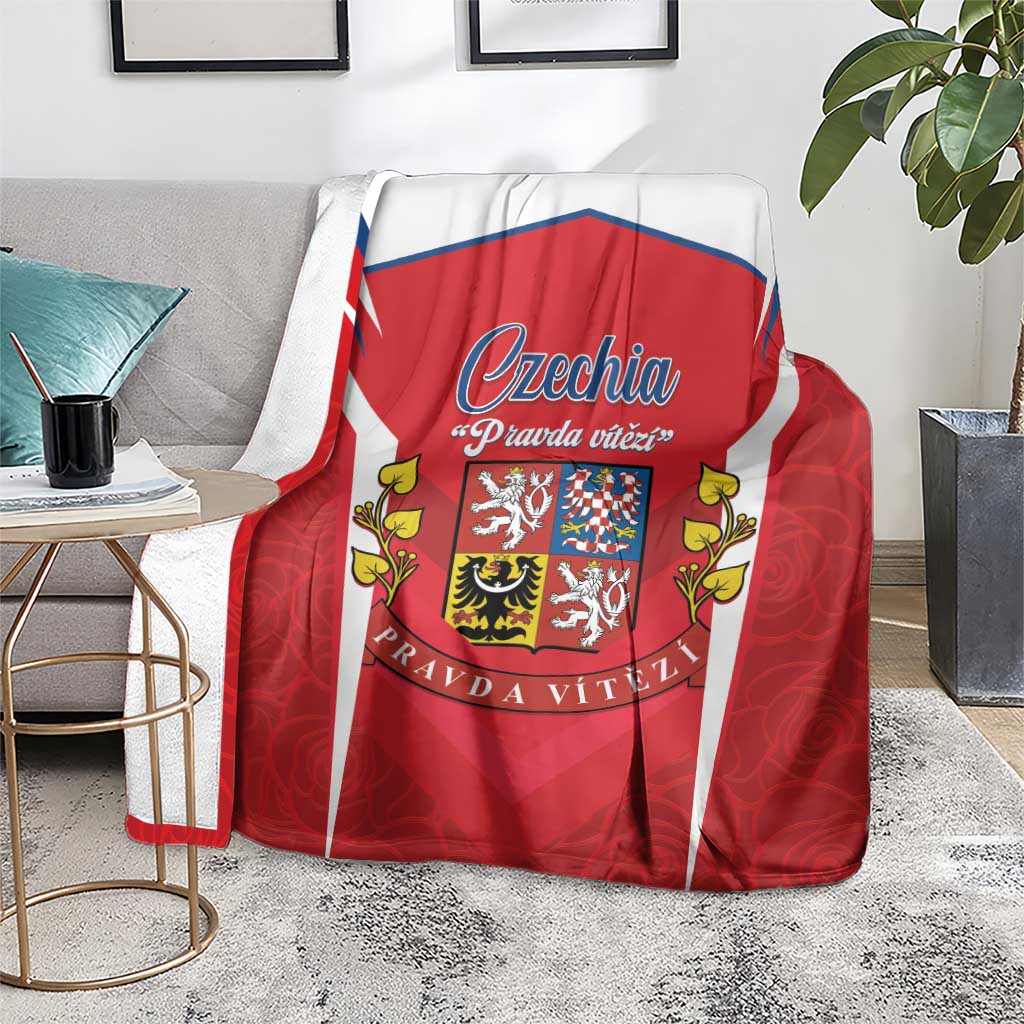 Red and white Czech crest blanket draped over sofa with blue emblem center