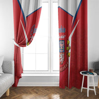Red Czech flag window curtain panels tied at the center over a white-framed window