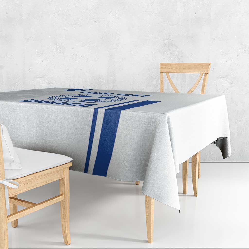 White tablecloth with blue central stripe and Greece crest design on table