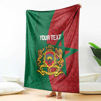 Personalized Moroccan blanket draped with green and red geometric pattern and crest