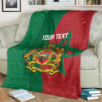 Personalized Moroccan blanket over couch with green/red geometric pattern and crest