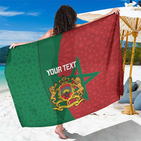 Personalised beach sarong with green and red geometric pattern, crest and “YOUR TEXT”