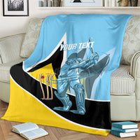 Blue cricket blanket on sofa with player graphic, black/yellow design, and 'YOUR TEXT'.