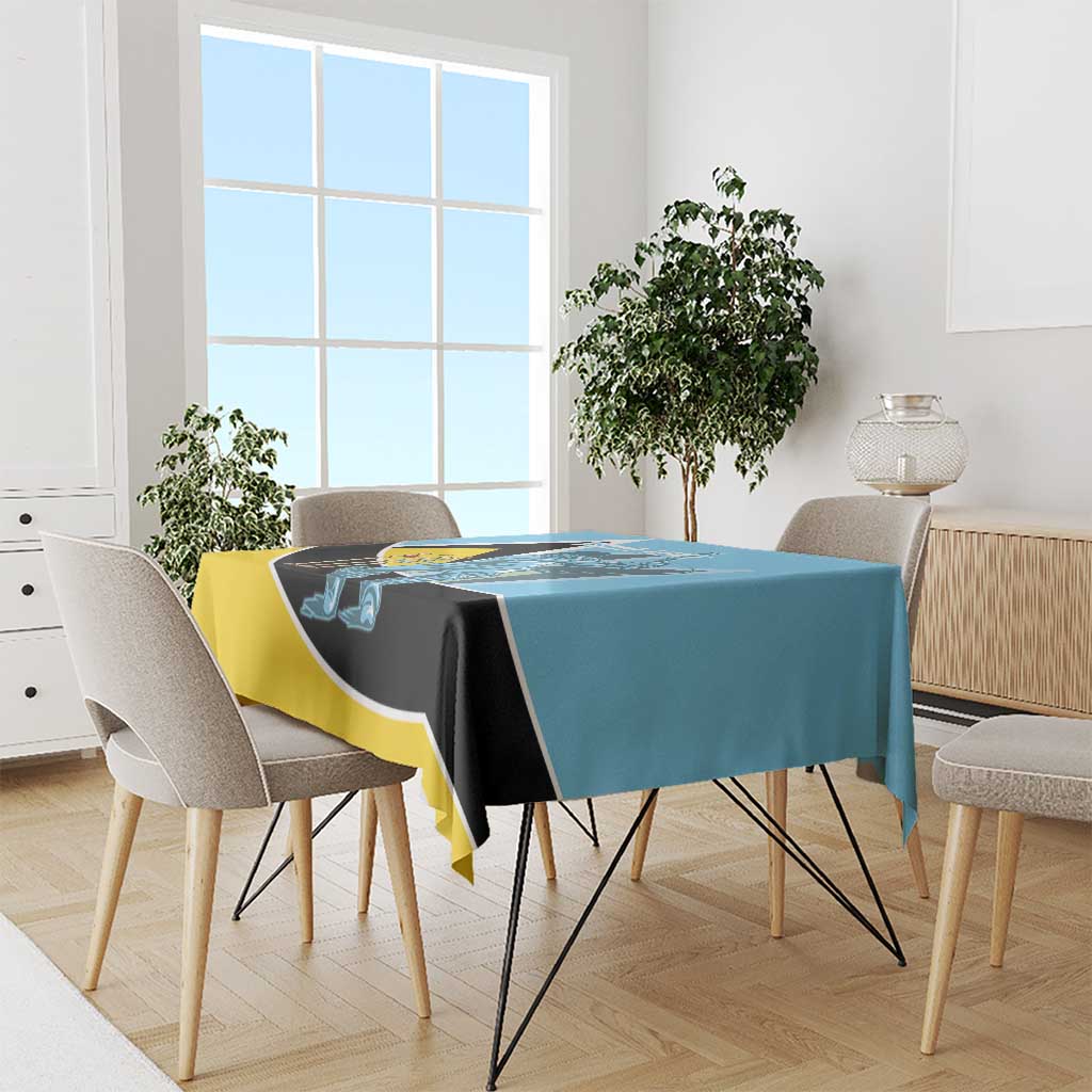 Tablecloth draped on dining table, blue top with black and yellow border and cricket print