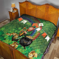 Green St. Patrick’s quilt on bed, leprechaun with harp, black cauldron and gold coin graphics