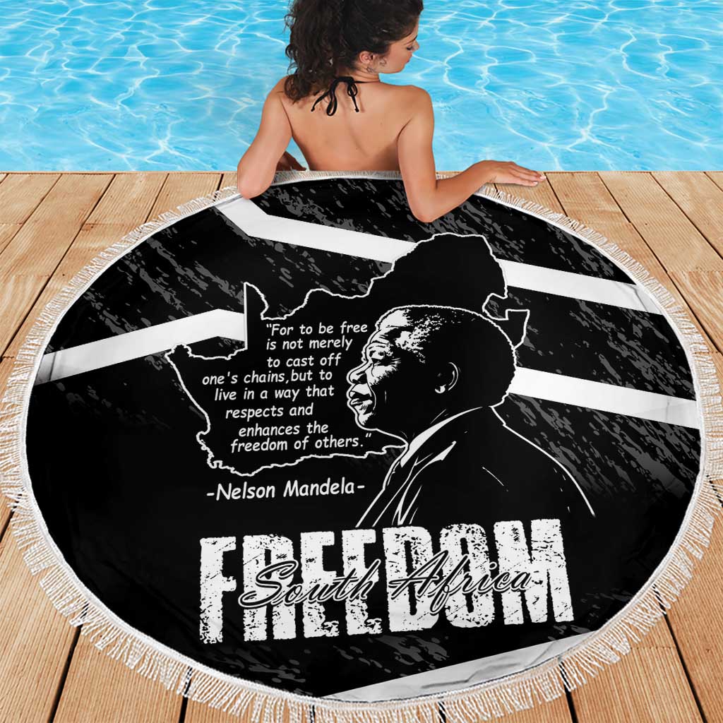 Black round beach blanket with Mandela portrait and Freedom South Africa print, draped on person