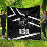 Black quilt with white diagonal stripes, Mandela portrait print, and Freedom wording
