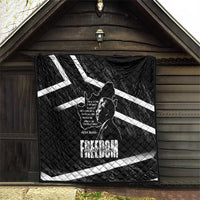Black quilt hanging on wall with white diagonal stripes and Mandela portrait print
