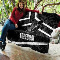 Black quilt spread out with white diagonal stripes and Mandela portrait graphic