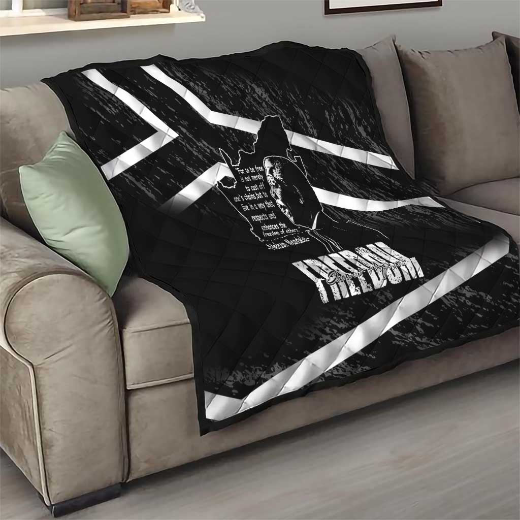 Black quilt draped on sofa with white diagonal stripes and Mandela portrait design