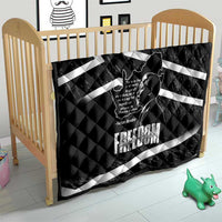 Black quilt laid in baby crib with white diagonal stripes and Mandela portrait print