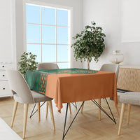 Custom cricket tablecloth with green Celtic panel and orange cloth on dining table.