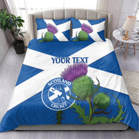 Blue and white duvet and pillow set with custom text, thistle design, and Scotland Cricket logo