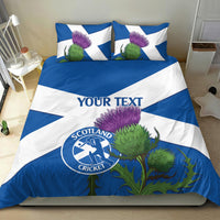 Blue and white duvet and pillow set with custom text, thistles, and Scotland Cricket logo