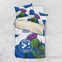Blue and white bedding set with custom text, purple thistles, and Scotland Cricket logo