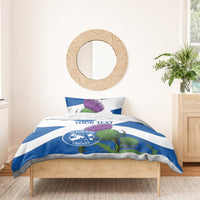 Blue and white duvet cover with custom text, thistles, and Scotland Cricket emblem