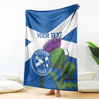 Blue and white Scotland cricket blanket with thistle print and 'YOUR TEXT' center